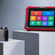 KINGBOLEN red diagnostic tablet with home screen next to an OBD2 diagnostic tool on studio pedestals
