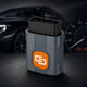Full-system scan before and after repair: OBD2 dongle in front of a car and instrument cluster