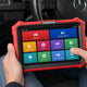 Best OBD2 scanner for Mercedes-Benz in 2026: a KINGBOLEN diagnostic tablet in a Mercedes cabin, with the OBD2 adapter plugged in