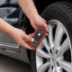 How to use a TPMS relearn tool: a KINGBOLEN EL-50448 held at a Chevrolet wheel valve stem