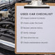 Used car inspection checklist: a clipboard over an open engine bay, covering exterior, hood, history, mileage, test drive, and maintenance records